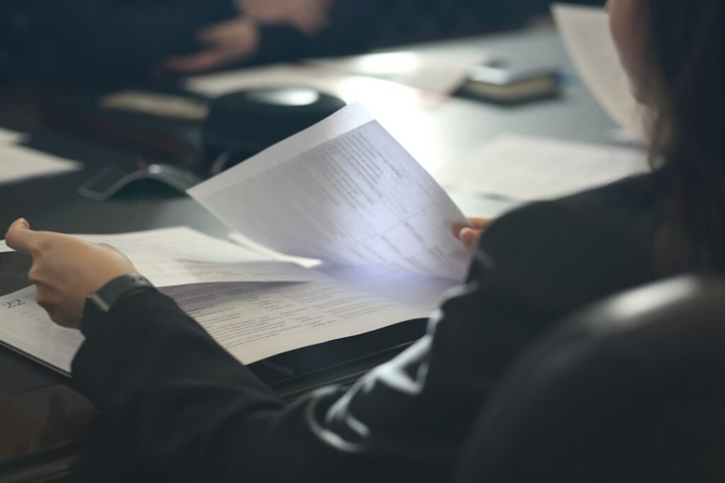 Applicant reviewing paperwork at a desk for a job application.