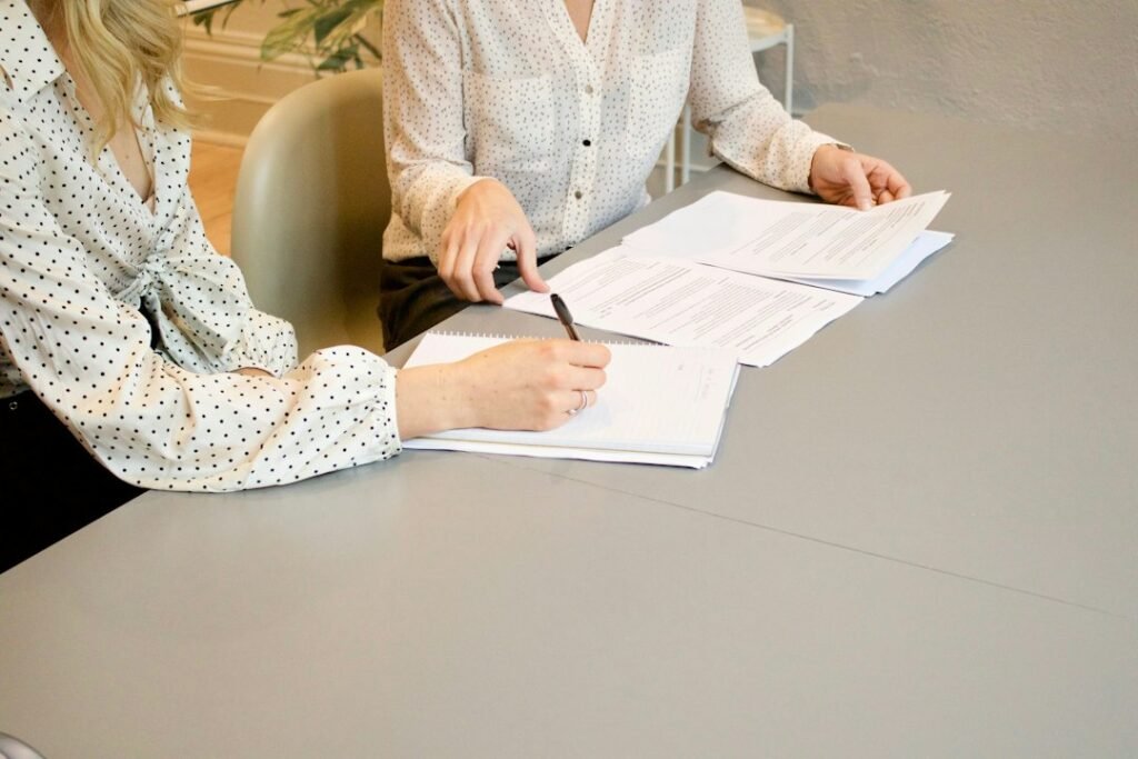 Applicant reviewing employment documents at a desk.