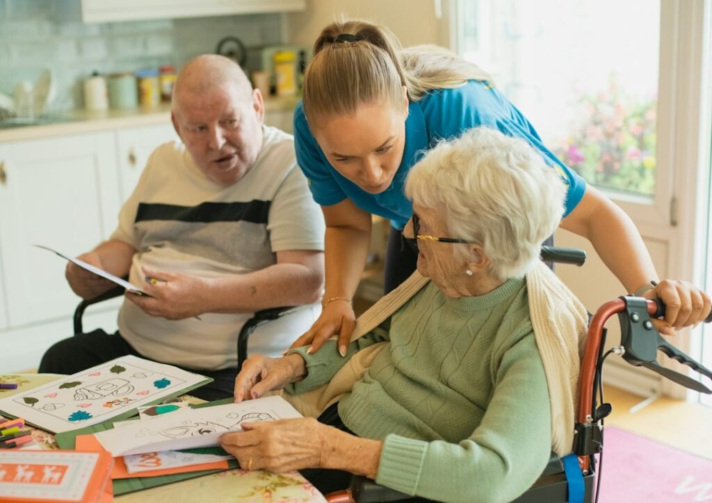 Caregiver assisting older adults in a care setting.