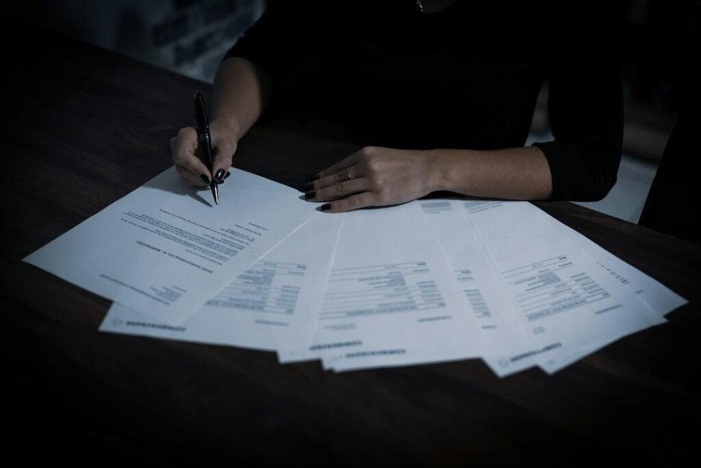People reviewing and signing employment documents.