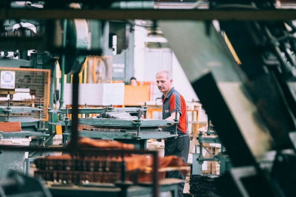 Factory worker operating machinery on a production line.