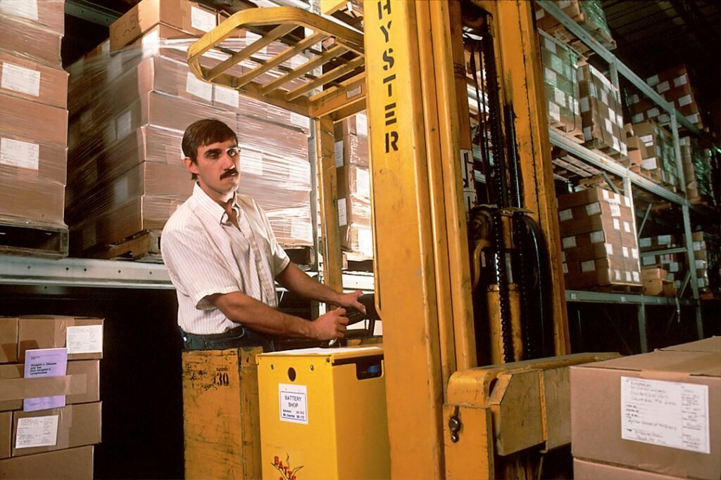 Forklift moving goods inside a warehouse.