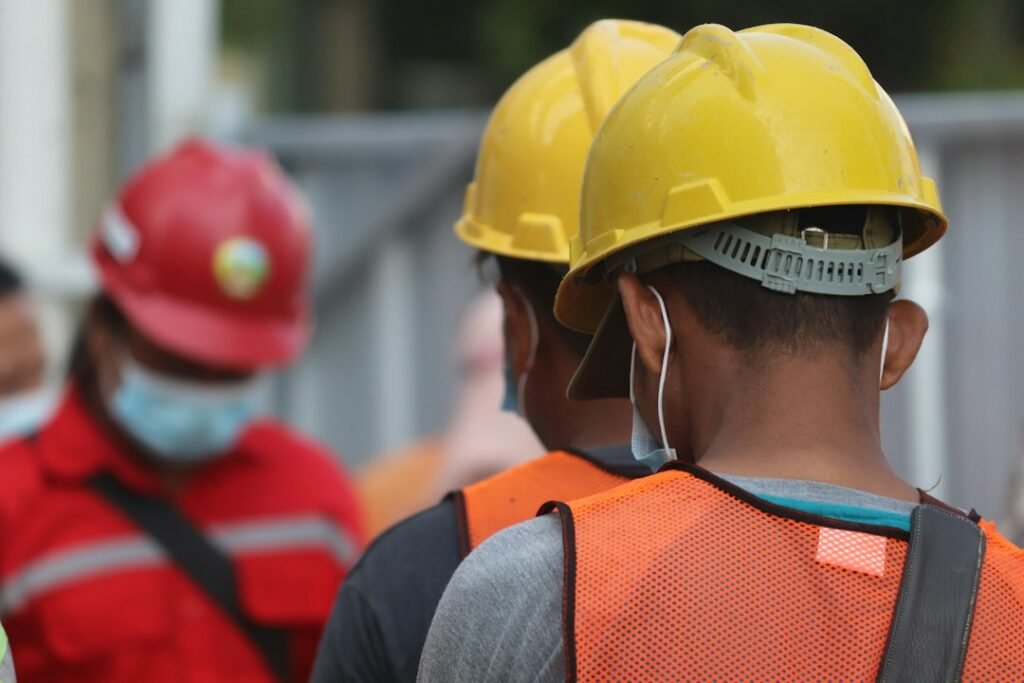 Construction worker wearing a hard hat and protective clothing.