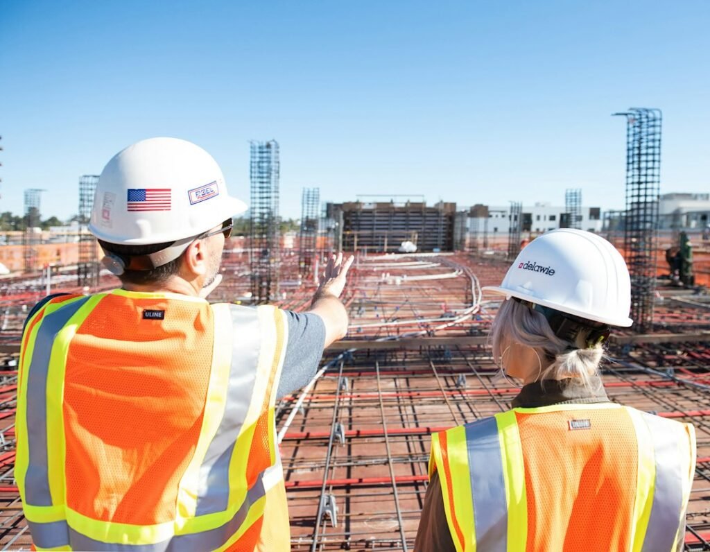 Construction workers in safety vests at a building project.